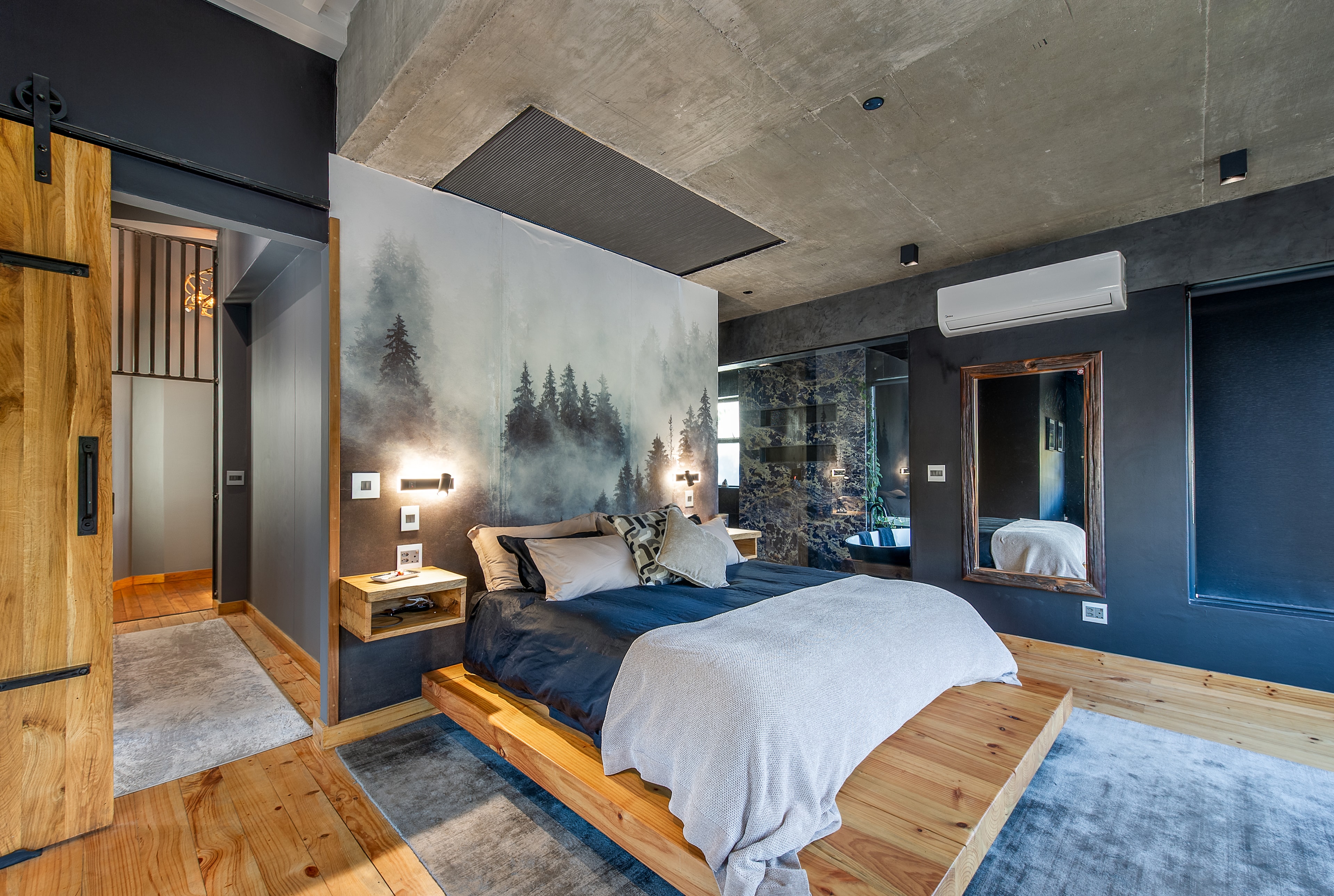 Bedroom with platform bed and forest views
