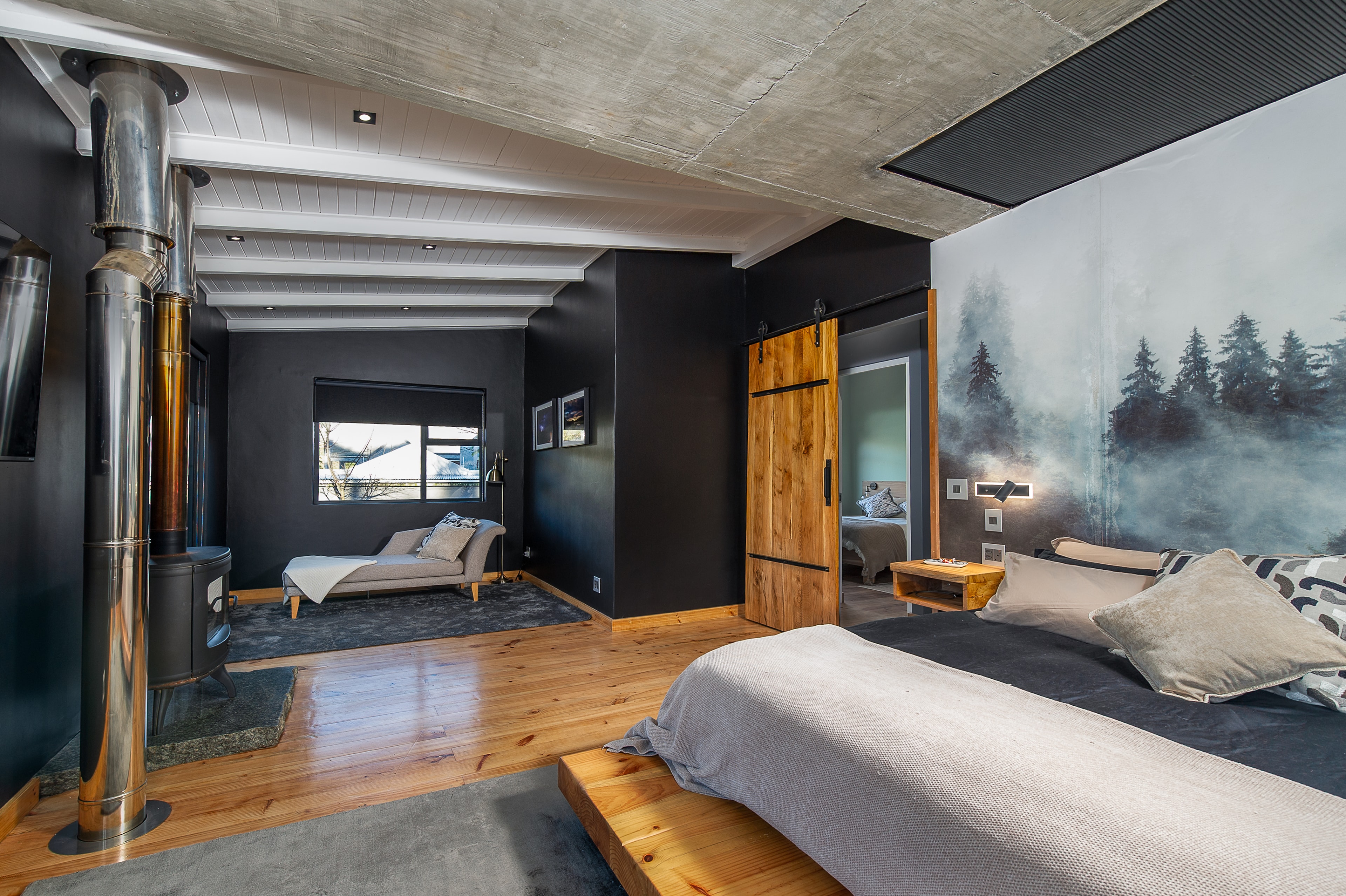 Bedroom with fireplace and forest mural