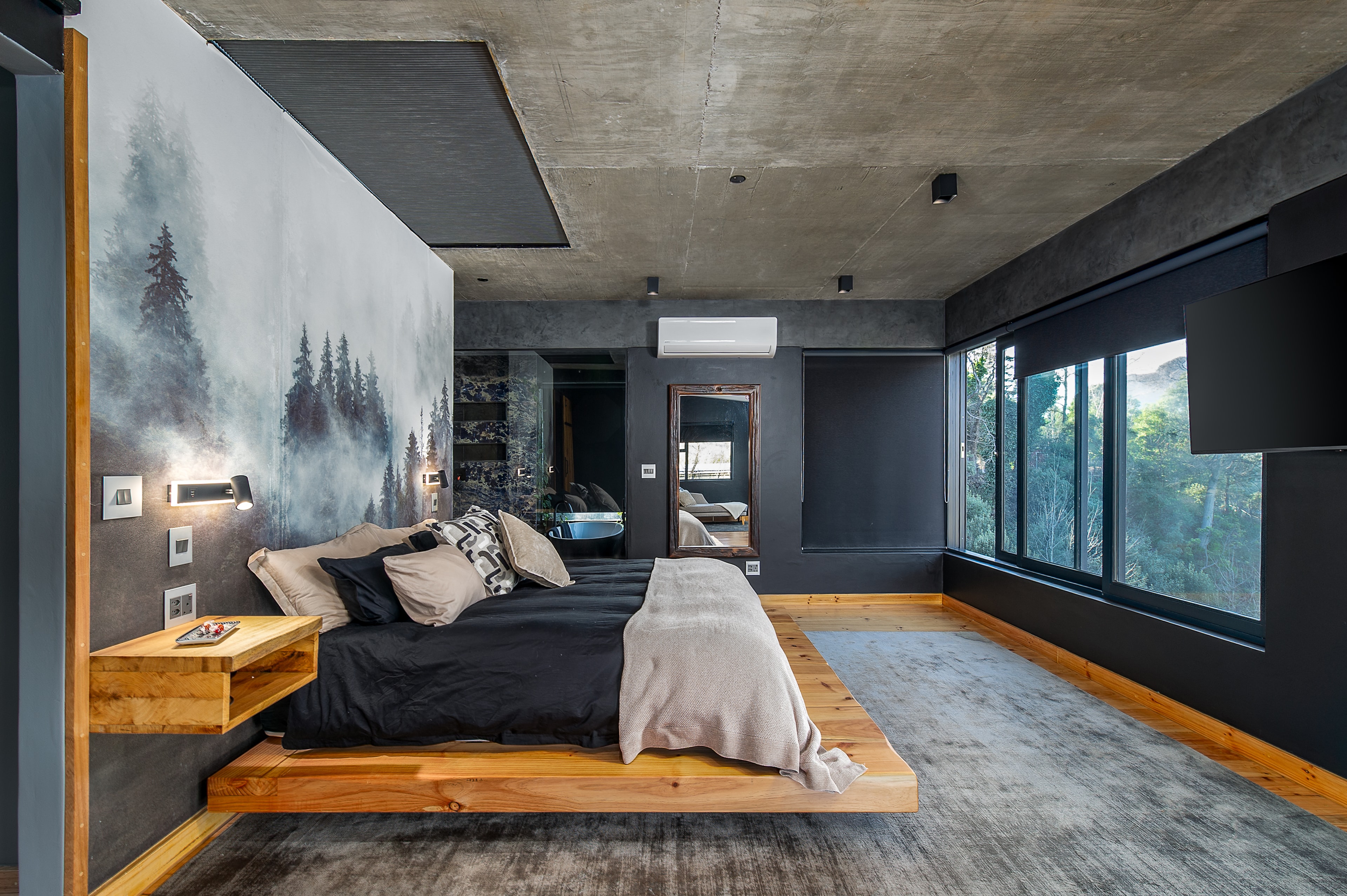 Bedroom with floor-to-ceiling forest windows